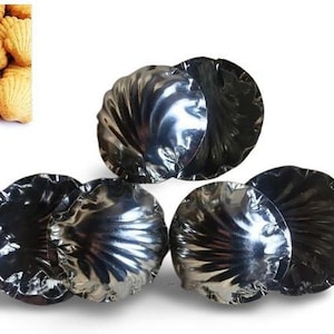 May include: Five silver-colored metal molds shaped like seashells. The molds are arranged in a triangular shape.