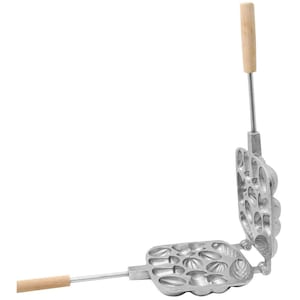 May include: A silver metal waffle iron with wooden handles. The iron has a square shape and is divided into 12 sections, each with a different design. The iron is open, showing the inside of the sections.