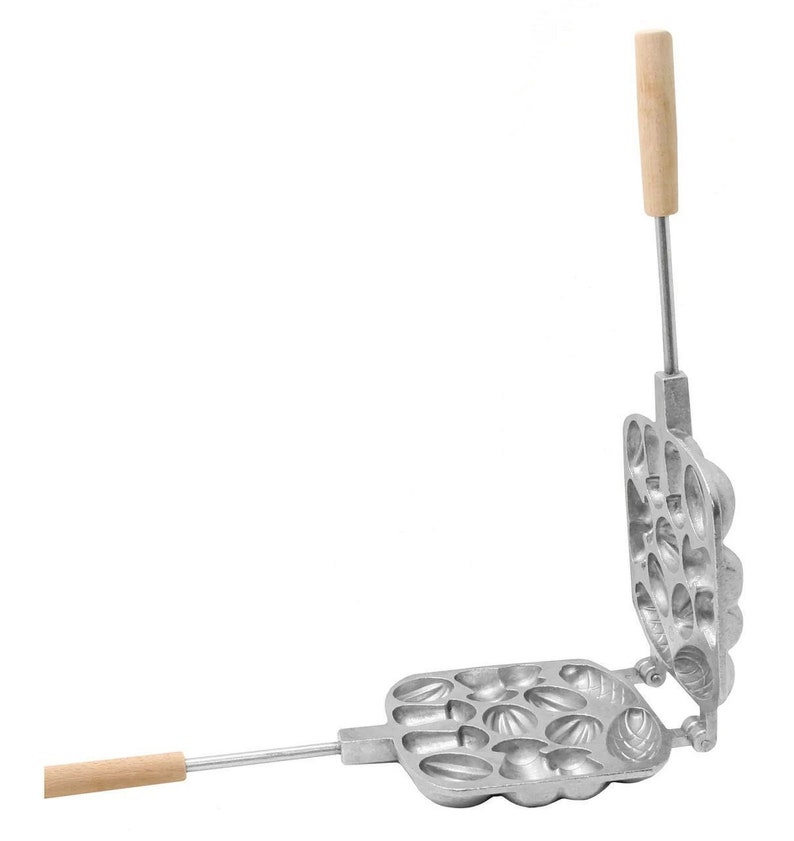 May include: A silver metal waffle iron with wooden handles. The iron has a square shape and is divided into 12 sections, each with a different design. The iron is open, showing the inside of the sections.