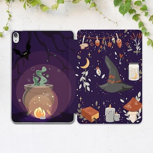 May include: A purple and black iPad case with a witchy theme. The front features a cauldron with green smoke and a fire underneath. The back features a witch's hat, a book, candles, and other witchy elements.