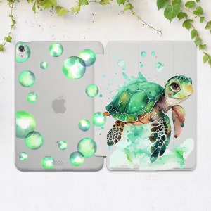 May include: A clear phone case with a green watercolor sea turtle and bubbles. The case is designed for an iPad.