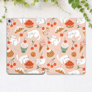 May include: A pink tablet case featuring a repeating pattern of white cats, cherries, pastries, and ice cream cones. The case is open, revealing the tablet screen and the interior design. The design is whimsical and playful.