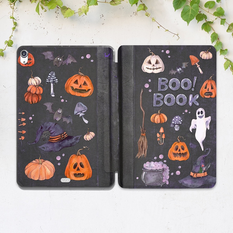 May include: A black and orange Halloween-themed phone case with a spooky design. The case features pumpkins, bats, witches, and the text "Boo! Book".