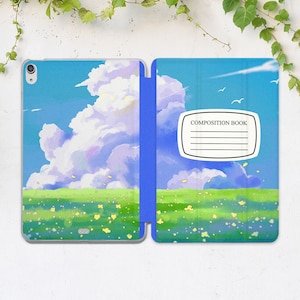 May include: A blue and white tablet case with a watercolor illustration of a field with clouds and the text "COMPOSITION BOOK".