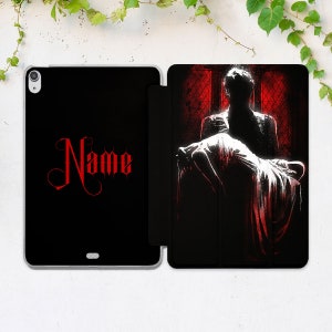 May include: Black and red iPad case with a silhouette of a person carrying another person. The case has the word "Name" in red on the front.