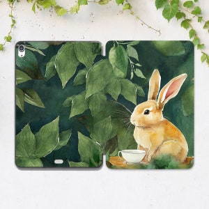May include: A watercolor illustration of a brown rabbit sitting in a forest setting with green leaves. The rabbit is holding a white teacup.