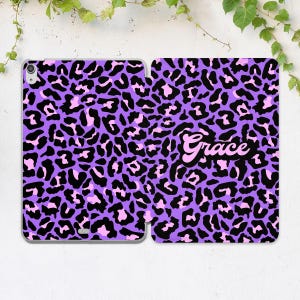 May include: Purple and pink leopard print phone case with the name "Grace" in pink letters.