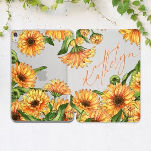 May include: A clear phone case with a floral design featuring orange and yellow sunflowers and green leaves. The name "Katelyn" is written in cursive on the case.