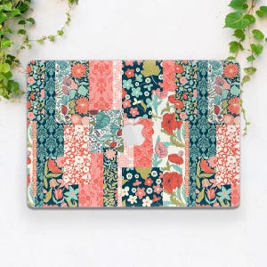 May include: A floral patchwork laptop case featuring a variety of patterns and colors. The design includes red poppies, small white flowers, and teal and pink floral patterns. The case has a cutout for the Apple logo.