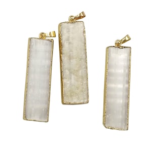 May include: Three gold-plated selenite crystal pendants, each with a rectangular shape and a white, translucent finish. The crystals have a striated texture and are set in a gold frame.