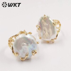 May include: Two gold rings with large, irregular, white baroque pearls. The rings have a delicate, branch-like design.