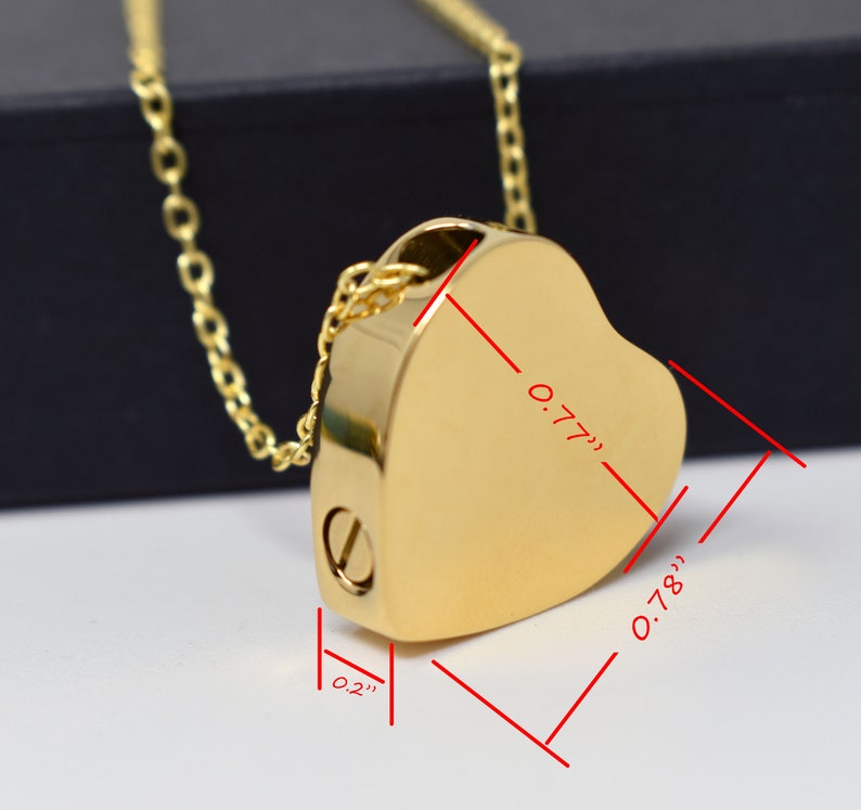 May include: A gold-colored heart-shaped pendant necklace. The pendant measures 0.77 inches wide, 0.78 inches high, and 0.2 inches thick. The necklace has a delicate chain and a screw closure on the side.