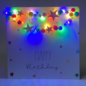 Light up birthday card, copper wire multi colour garland, pompoms and rose gold stars
