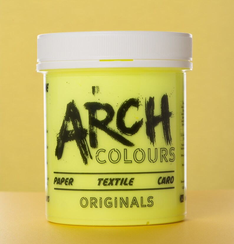 May include: A yellow plastic jar of neon yellow paint with the text "ARCH COLOURS ORIGINALS" and "PAPER TEXTILE CARD" printed on the label.