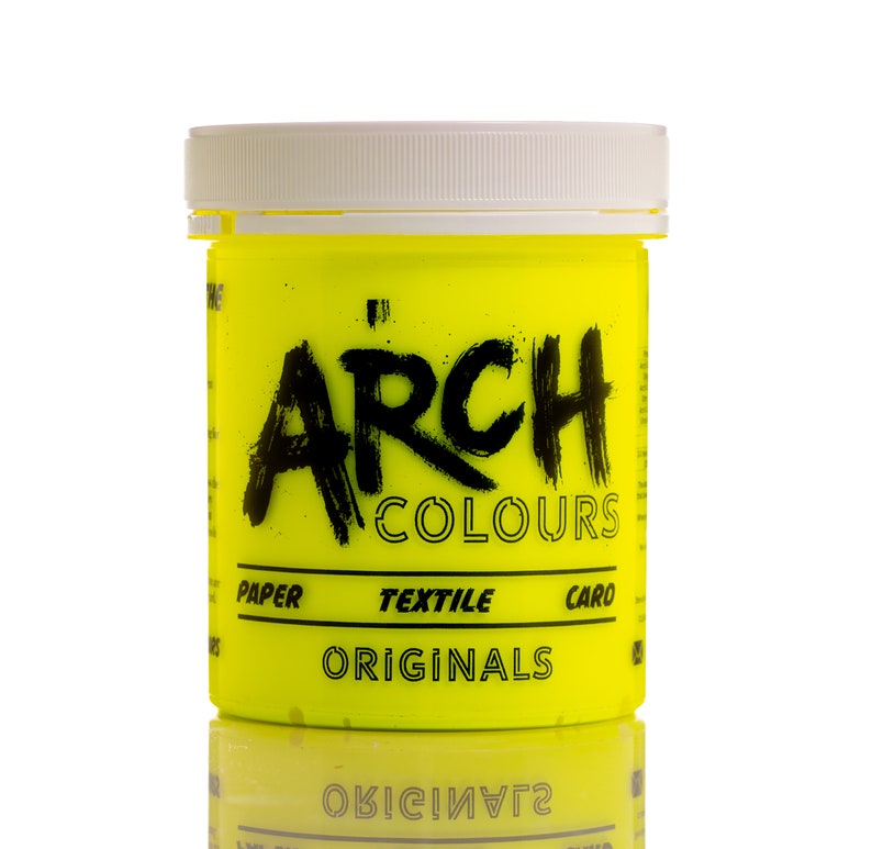 May include: A yellow plastic bottle of Arch Colours Originals fabric dye. The bottle has black text that reads "Arch Colours" and "Paper Textile Caro Originals".