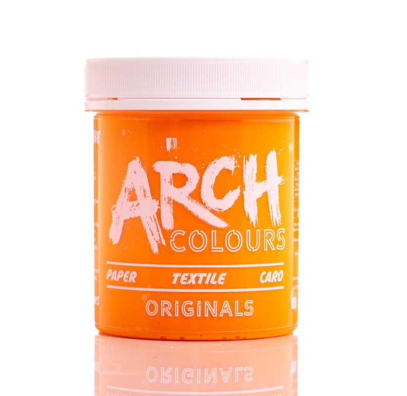 May include: Orange colored jar of paint with a white lid. The jar has the text "ARCH COLOURS" in white lettering and the words "PAPER TEXTILE CARO ORIGINALS" in white lettering.
