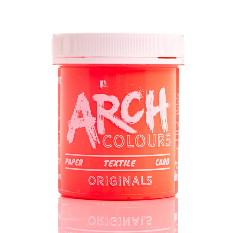 May include: A bright pink plastic jar of hair dye with the text "ARCH COLOURS ORIGINALS" on the front. The jar is labeled for use on paper, textile, and hair.