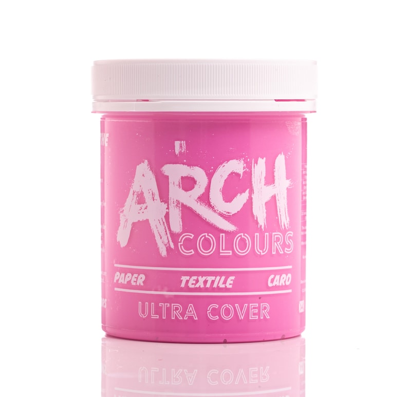 May include: A pink plastic jar of Arch Colours Ultra Cover paint. The jar has a white lid and the text "ARCH COLOURS" and "ULTRA COVER" is printed on the front.