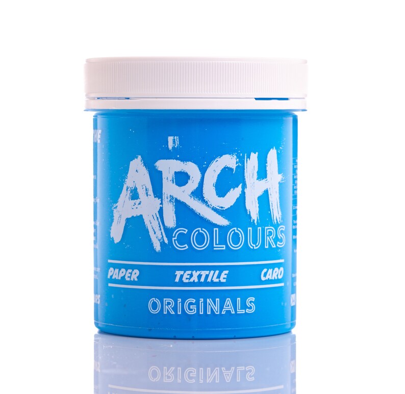 May include: A blue plastic jar of fabric dye with the text "Arch Colours Originals" and the words "Paper, Textile, Card" printed on the label.