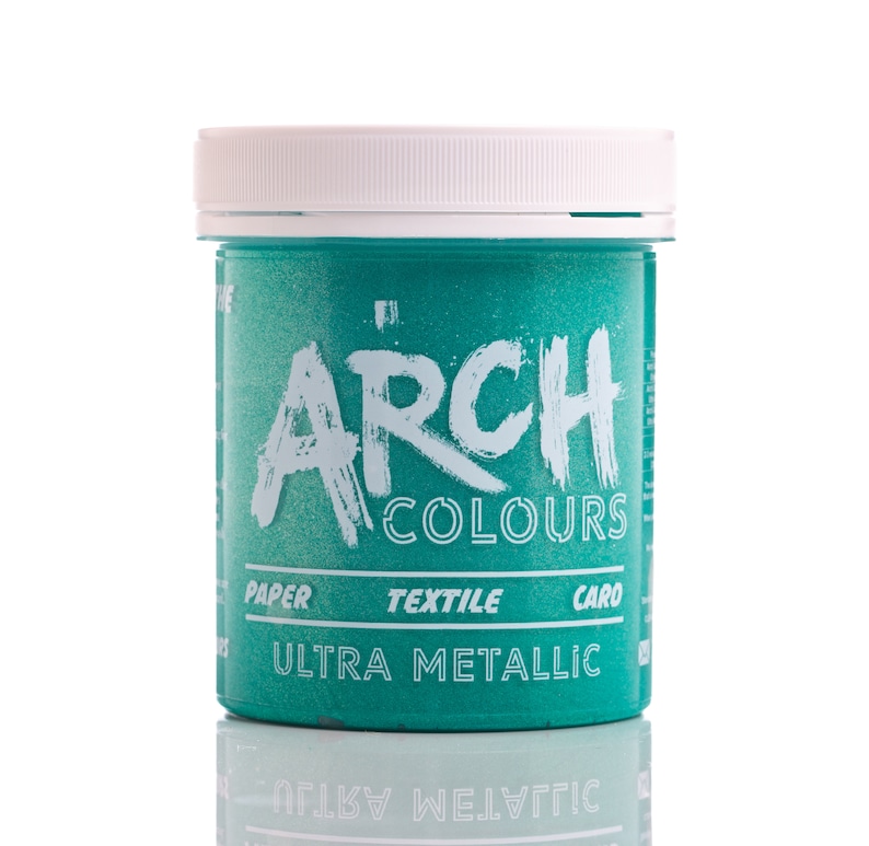 May include: A round plastic jar of teal blue metallic paint with a white lid. The jar has the words "Arch Colours" and "Ultra Metallic" printed on the front.