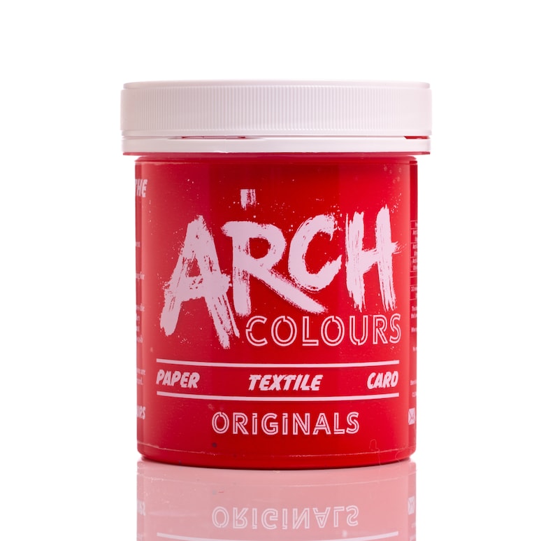May include: A red plastic jar of Arch Colours Originals dye. The jar has a white lid and white text that reads "Arch Colours" and "Paper Textile Card Originals".