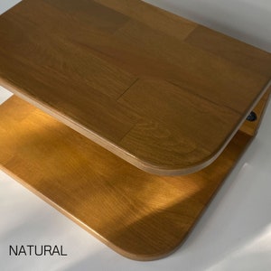 May include: A two-tiered wooden shelf with rounded edges. The shelf is made of natural wood and has a light brown color. The shelf is labeled "NATURAL".