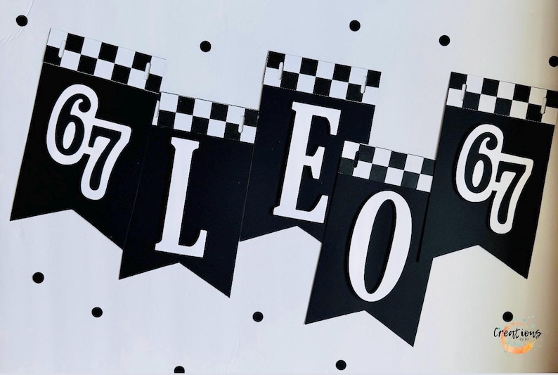 May include: Black and white banner with the word "LEO" and the number "67" in white. The top of each banner has a checkered pattern. Black polka dots are scattered on the white background.