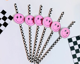 May include: A set of six paper straws with pink smiley face toppers featuring lightning bolts. The straws have a black and white checkered pattern. The image also includes a checkered flag design.