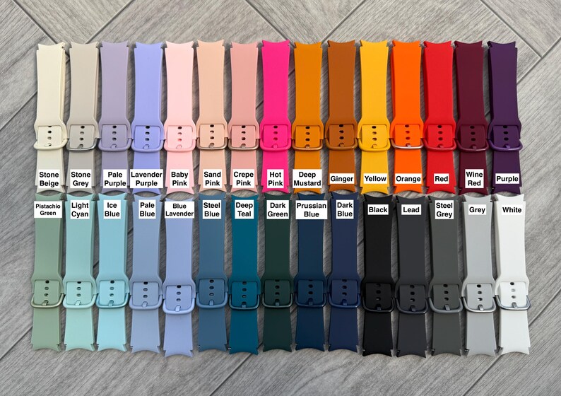 May include: A collection of colorful watch bands in various shades, including beige, pink, blue, green, orange, and black. Each band is labeled with its color name, such as "Stone Beige," "Hot Pink," and "Red."
