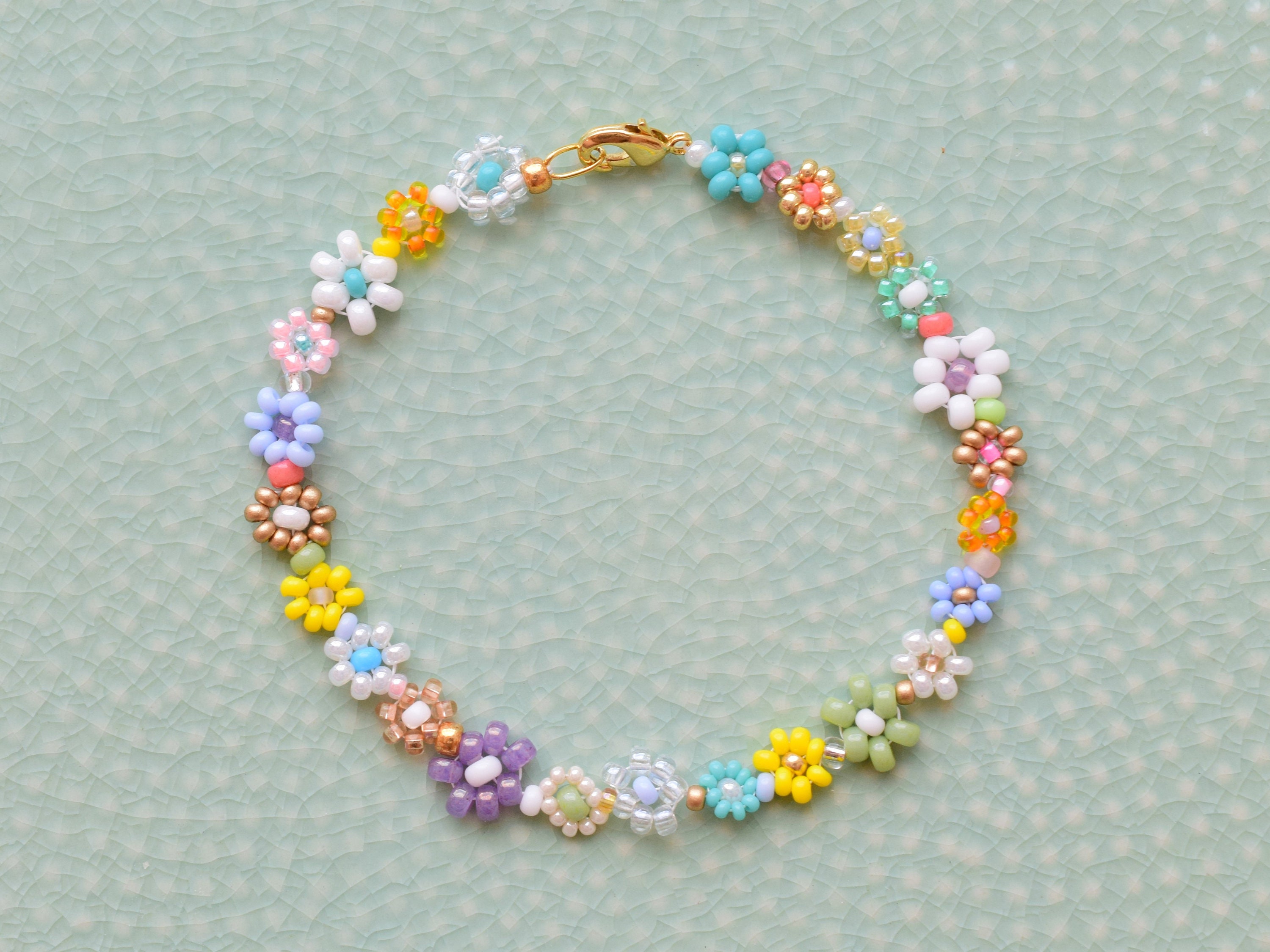 How to Make Seed Bead Daisy Flower Bracelets - MuffinChanel | Making  bracelets with beads, Friendship bracelets with beads, Flower bracelet diy