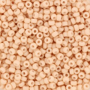 May include: A large quantity of small, round, opaque, light peach-colored beads.