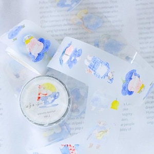 May include: A roll of decorative tape with a watercolor illustration of a girl in a teacup, with the text "seasons quartet vol. 2". The tape also features repeating illustrations of figures in blue and white clothing.