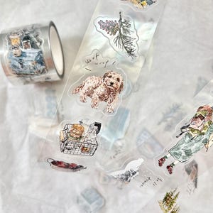 Może przedstawiać: Rolka ozdobnej taśmy washi i przezroczyste naklejki z akwarelowymi ilustracjami. Taśma przedstawia scenę kempingową, a naklejki przedstawiają psa, jedzenie i elementy natury. Naklejki mają napis "Woof woof!"