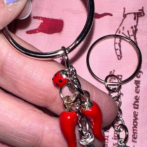 Italian Cornicello mano Cornuta Hamsa Amulet Trio Keychain Malocchio chant English language translation gift lucky horseshoe keychain gift