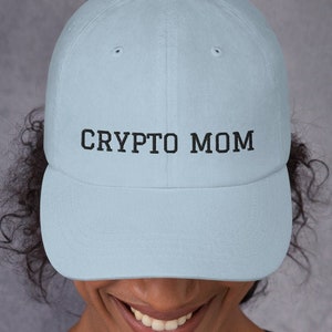 May include: A light blue baseball cap with black embroidered text that reads "CRYPTO MOM".