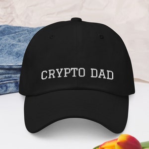 May include: Black baseball cap with white embroidered text that reads "CRYPTO DAD".