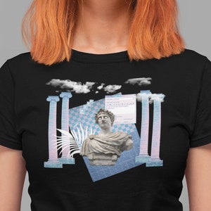 May include: A black t-shirt with a graphic design featuring a bust of a classical statue, columns, and a blue and white checkered pattern. The text "ERROR 404" is visible on a blue rectangle.