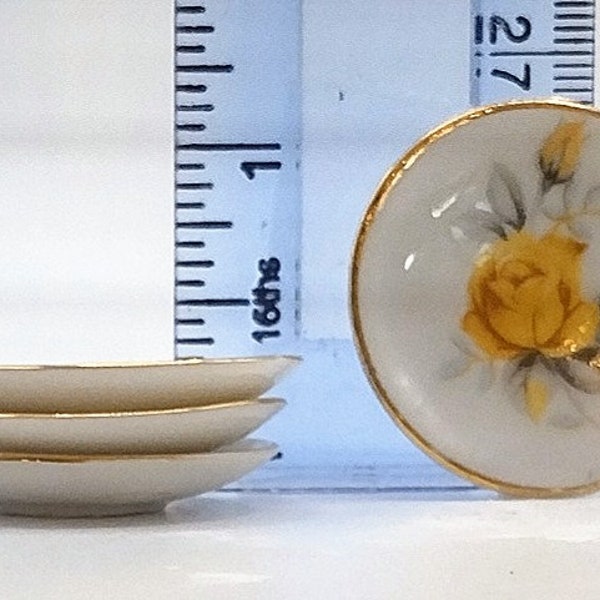 Set of four miniature china plates with rose motif