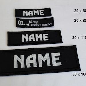 Könnte beinhalten: Schwarze rechteckige Aufnäher mit weiß gesticktem Text. Die Aufnäher zeigen das Wort "NAME" in verschiedenen Größen sowie einen Aufnäher mit einer Telefonnummer. Die Maße sind in Millimetern angegeben.