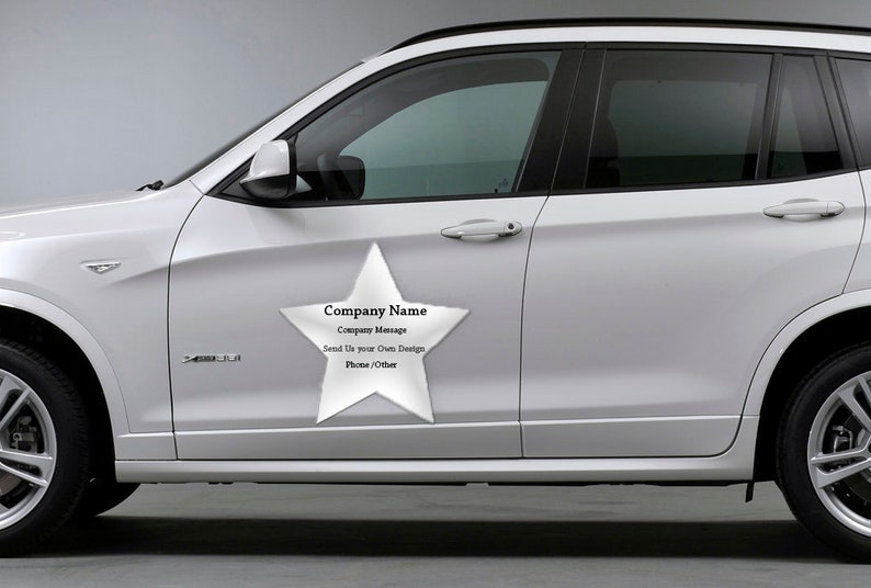 May include: A white car with a large white star-shaped magnet on the side. The magnet has the text "Company Name", "Company Message", "Send Us your Own Design", and "Photo/Other" printed on it.