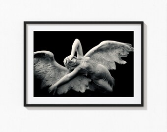 Grieving winged angel laying on her back over a tomb. Religious fine art photography print for home spiritual wall décor.