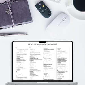May include: A laptop screen displaying a document titled Detailed Therapy Interventions with an alphabetical list of clinical words and phrases. Nearby are a dark gray notebook with a silver charm, a black car key fob, a white computer mouse, and a pen.