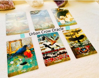 May include: A set of Urban Crow Oracle cards with colorful illustrations of crows and other imagery. The cards feature words like "Freedom", "Perspective", "Gifts", "Teamwork", "Release", and "Rebirth".