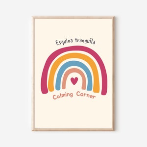 May include: A printable wall art print with a rainbow design in shades of pink, orange, yellow, blue, and red. The rainbow has a small heart in the center. The text "Esquina tranquila" is at the top of the rainbow and "Calming Corner" is at the bottom.