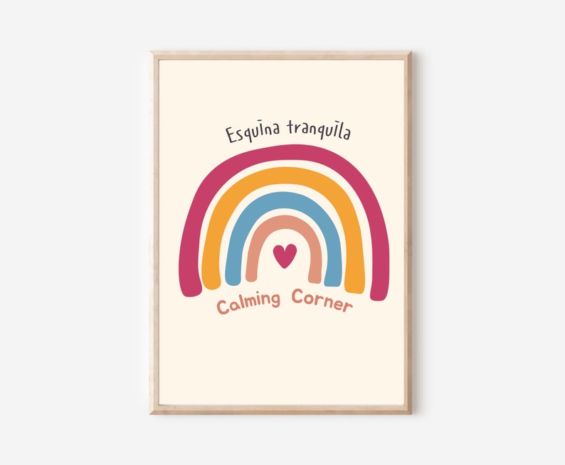 May include: A printable wall art print with a rainbow design in shades of pink, orange, yellow, blue, and red. The rainbow has a small heart in the center. The text "Esquina tranquila" is at the top of the rainbow and "Calming Corner" is at the bottom.