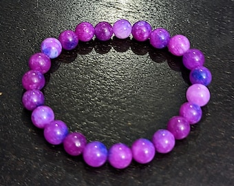 May include: A purple and blue gemstone bracelet with round beads.
