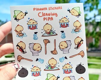 Puede incluir: Una hoja de pegatinas para planificadores con un pollo de dibujos animados limpiando. Las pegatinas son blancas con una variedad de imágenes con temática de limpieza, incluyendo un inodoro, una escoba, una aspiradora y un cubo. El texto "Planner Stickers Cleaning Pipa" está impreso en la parte superior de la hoja.
