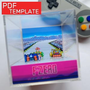 May include: A clear acrylic display featuring a retro video game scene with race cars on a track. The display has a pink base with the text "F-ZERO". The top left corner has a red rectangle with the text "PDF TEMPLATE". A Super Nintendo controller is in the background.