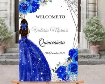 May include: Welcome to Victoria Maria's Quinceañera, a blue and silver sign with a blue dress and flowers.