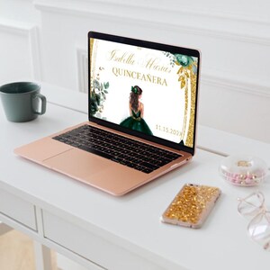 May include: A laptop computer displaying a digital invitation for a Quincea&ntilde;era. The invitation features a green and gold design with a floral border and the text "Isabella Maria Quincea&ntilde;era 11.13.2023".